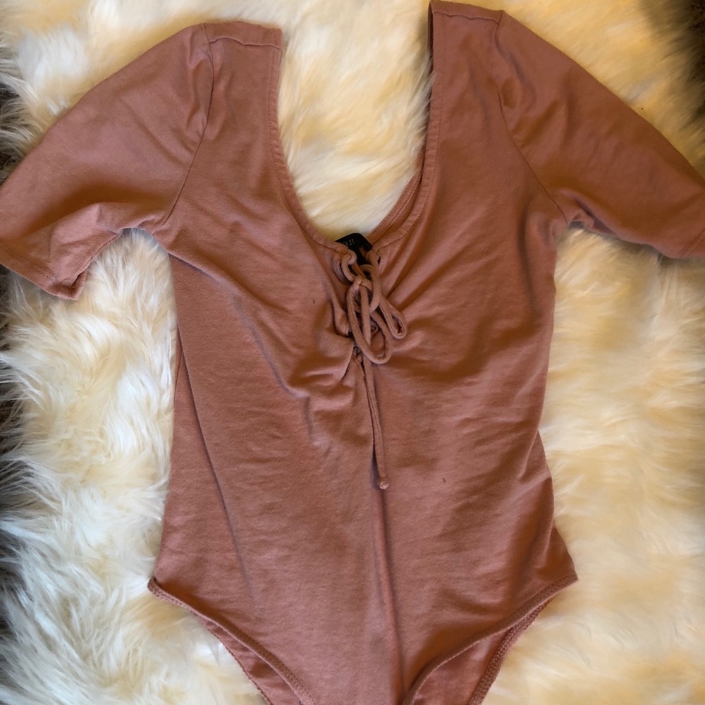 Peach colored body suit